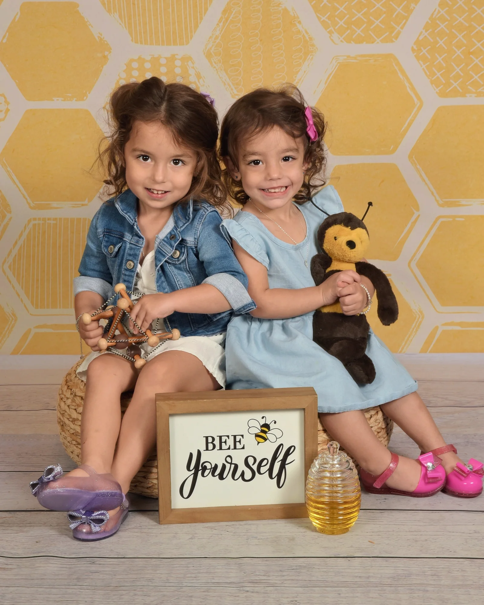 Adriana Reis's two daughters smiling together—the girls who continue to inspire her work.